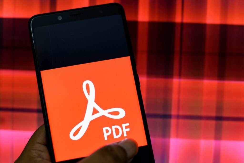 In this Photo illustration an Adobe PDF logo seen displayed on a Smartphone.