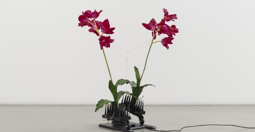 Anthropomorphic sculptures made of fake flowers and neck massagers