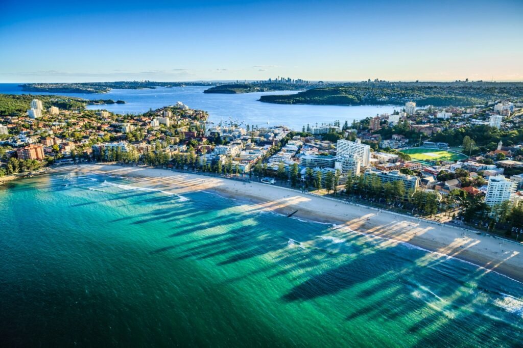 Aerial view of Sydney cityscape with ocean in foreground