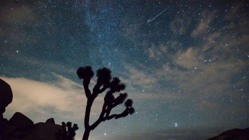 A lone meteor seen in the sky over a desert