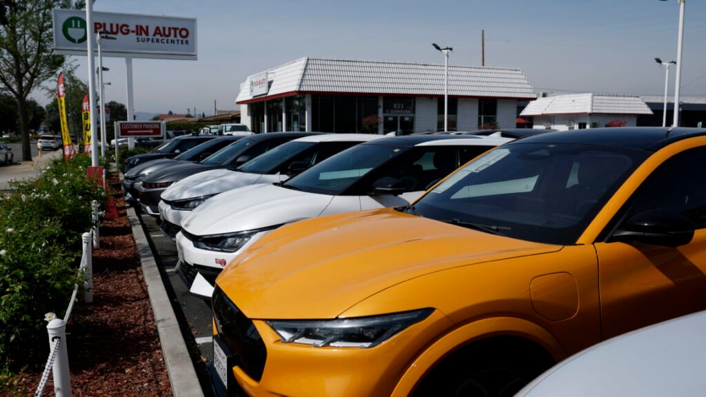 WEST COVINA, CALIFORNIA - MARCH 30: Used electric vehicles are displayed on the sales lot at Plug-In Auto on March 30, 2026, in West Covina, California. As gas prices surge amid the war in Iran, online automotive resource Edmunds reported a 22% increase in searches for electric vehicles during the week of March 2, as motorists look for ways to avoid high fuel costs. (Photo by Justin Sullivan/Getty Images)