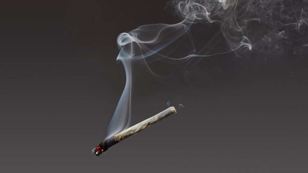 marijuana cigarette suspended in air with smoke wafting