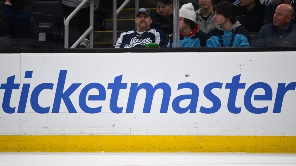 Jury finds Live Nation/Ticketmaster is illegal monopoly that overcharged fans A large Ticketmaster logo on the boards inside an ice hockey arena.