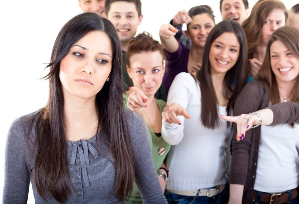 PSA: If you use the Meta AI app, your friends will find out and it will be embarrassing Crowd pointing fingers at a young woman