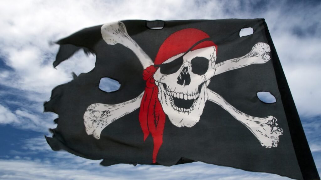 A pirate flag with a skull and crossbones blowing in the wind