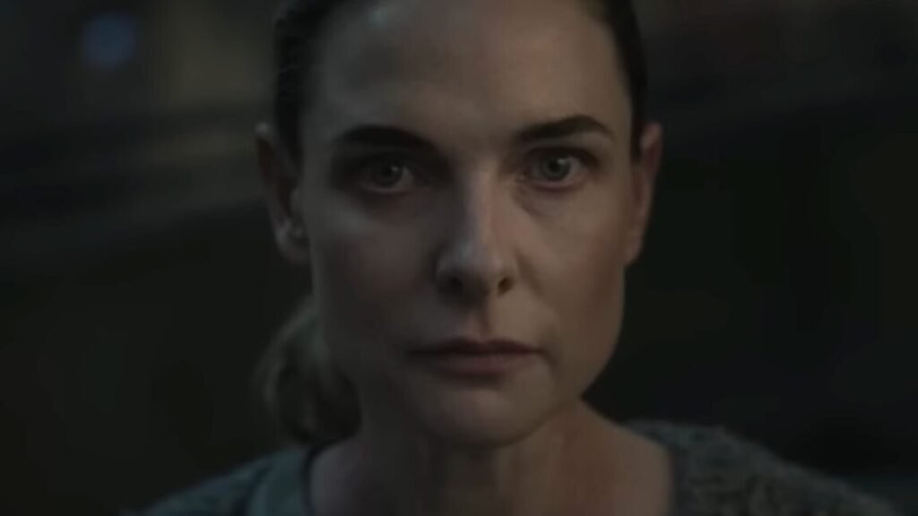 close up of woman with hair pulled back in a ponytail looking resolved