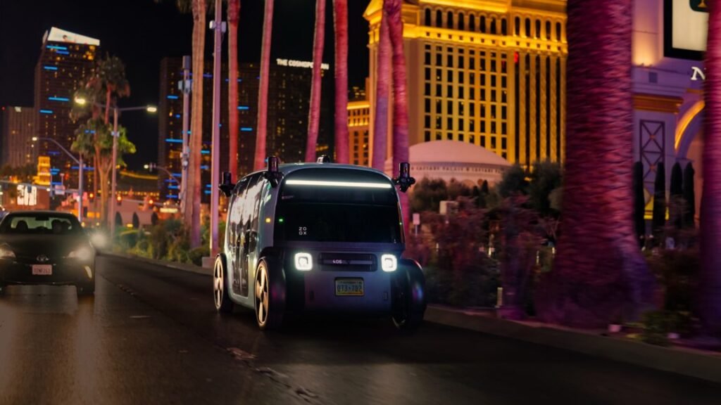 A zoox robotaxi drives down the Las Vegas strip at night