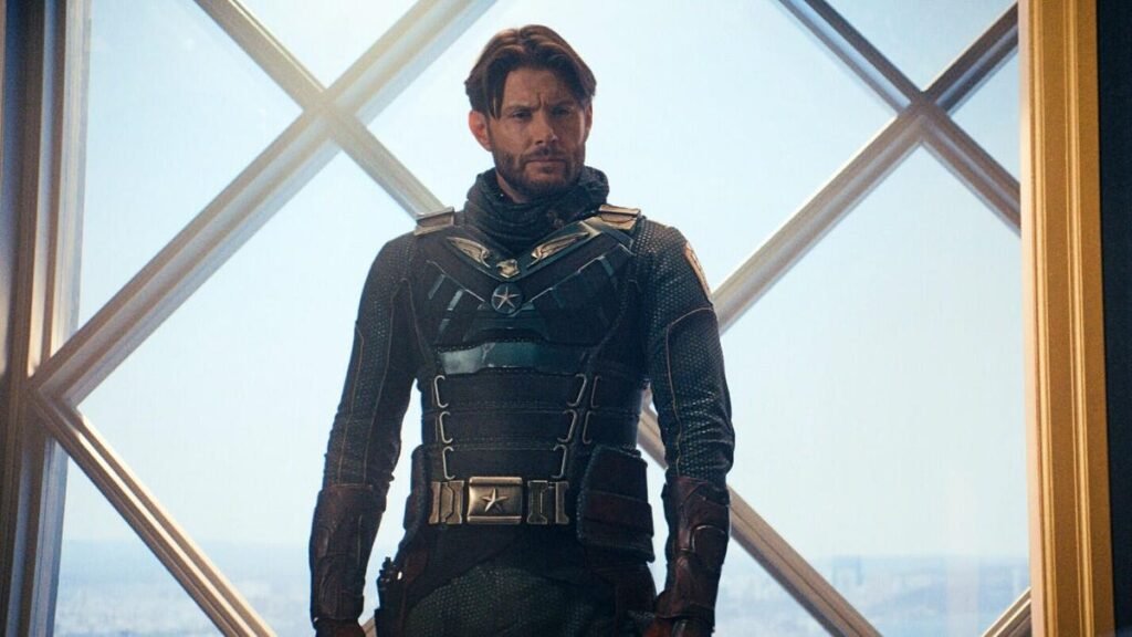 Production still from The Boys showing Jensen Ackles in his Soldier Boy superhero costume standing in front of a window.