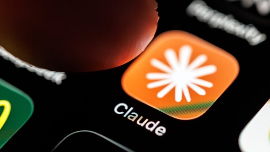 A person's finger hovering over the Claude AI app's icon on a phone screen.