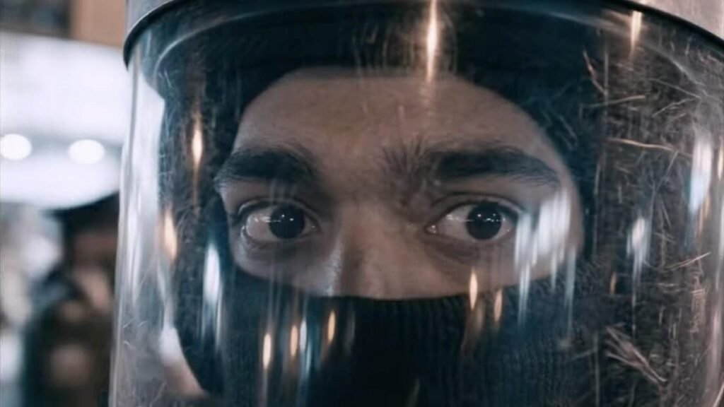 A closeup of the eyes of an Iranian man in a protective helmet.