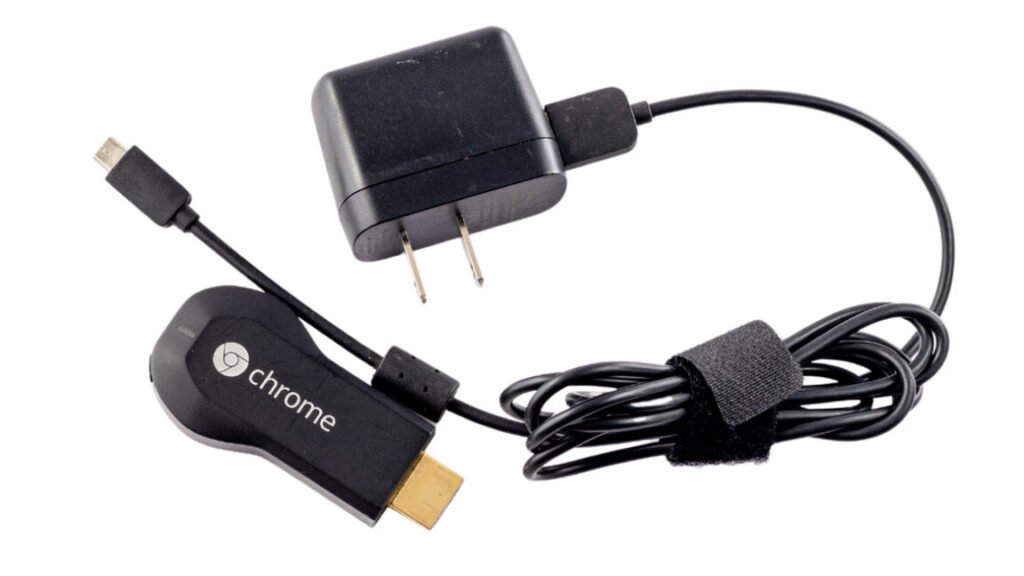 https://arstechnica.com/gadgets/2026/05/original-chromecast-lives-devices-back-on-after-mysteriously-breaking-this-week/1st generation Chromecast HDMI dongle isolated on white background.