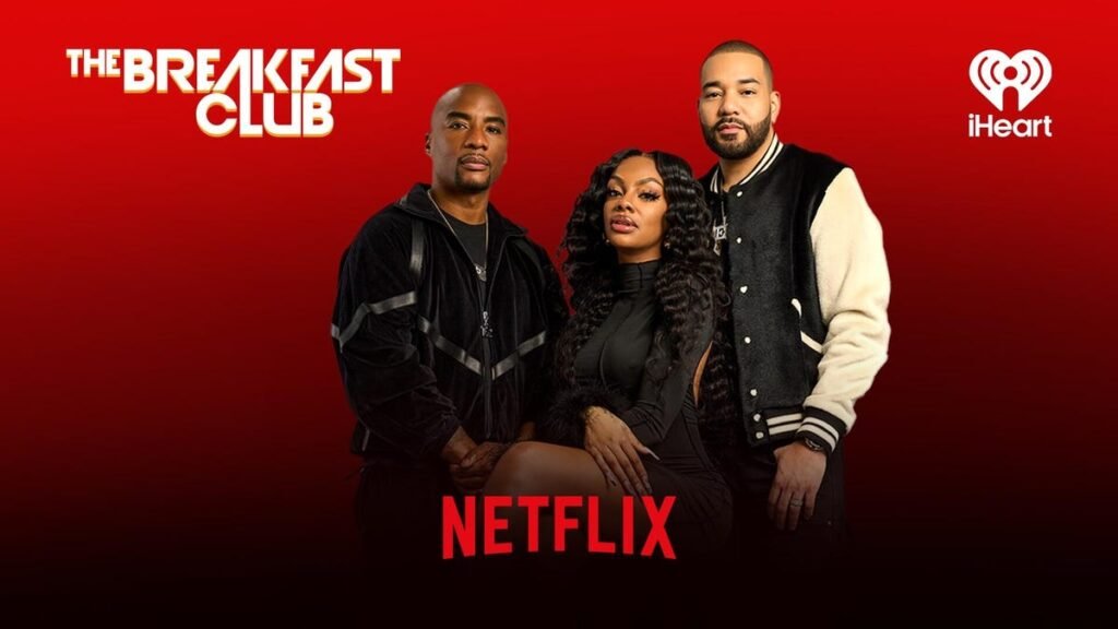 Charlamagne Tha God, Jess Hilarious and DJ Envy pose for a photo with red background and netflix logo