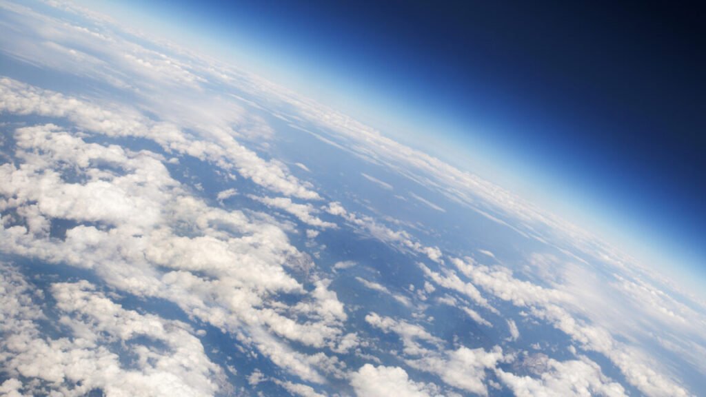 a view of Earth's atmosphere from above, with plenty of scattered clouds.