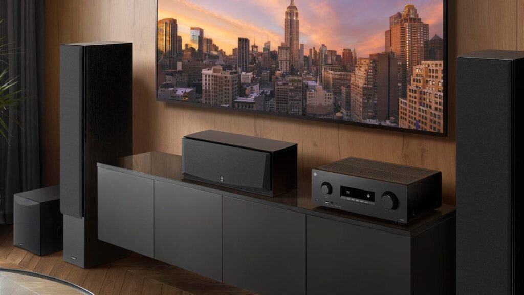 A Yahaham RX500A receiver sits on top of a cabinet between two tall speakers in a living room.