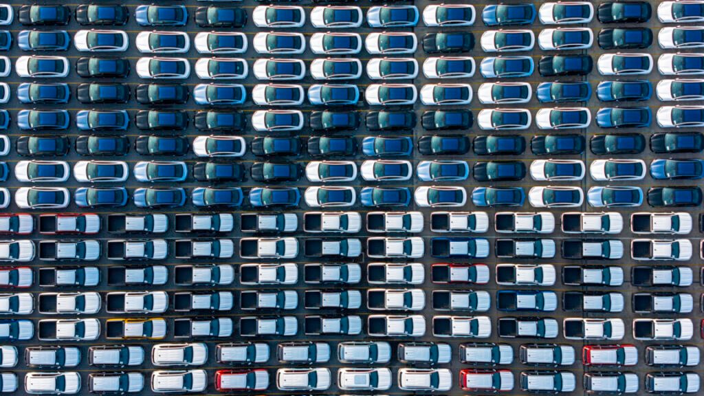 Image of vast rows of vehicles parked for storage.