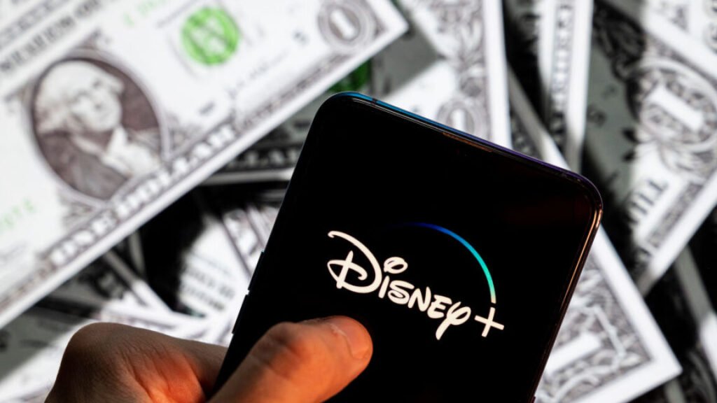 After jacking up prices, Disney+ and Netflix consider offering free alternatives Disney+ (plus), logo seen on an Android mobile device screen with the currency of the United States dollar icon, $ icon symbol in the background