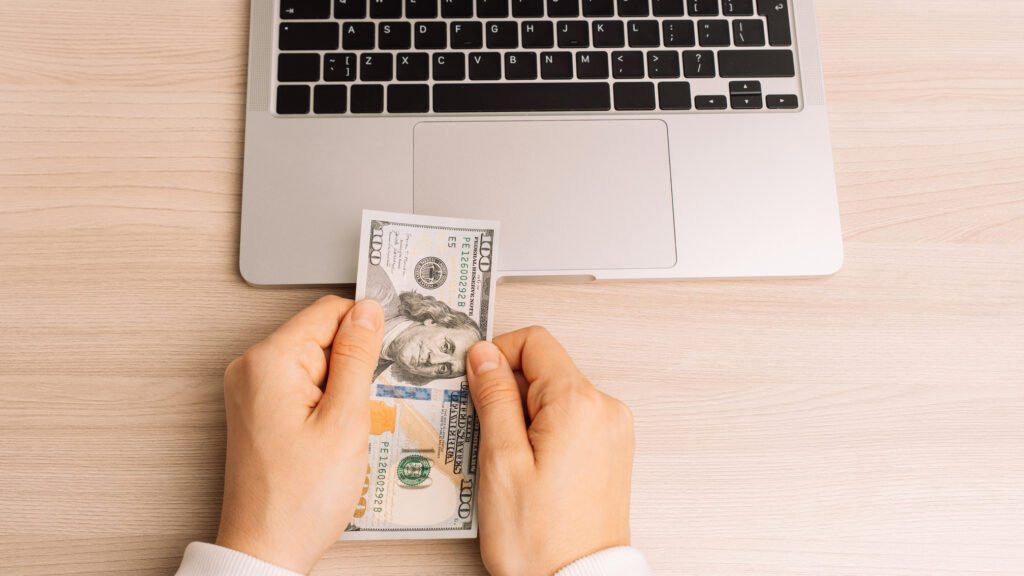 an image of money and laptop