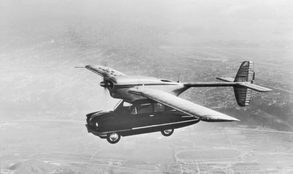 Black and white image of a flying car.