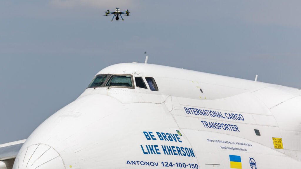A police drone takes off next to Ukrainian Antonov cargo plane at Leipzig/Halle Airport in Germany on August 5, 2026. Airport workers reportedly discovered a drone yesterday on the tarmac near an Antonov at the airport that was equipped with an explosives detonator and an unidentified substance. Additionally, a DHL cargo plane that took off from the airport late last night collided with a small object, causing minor damage.
