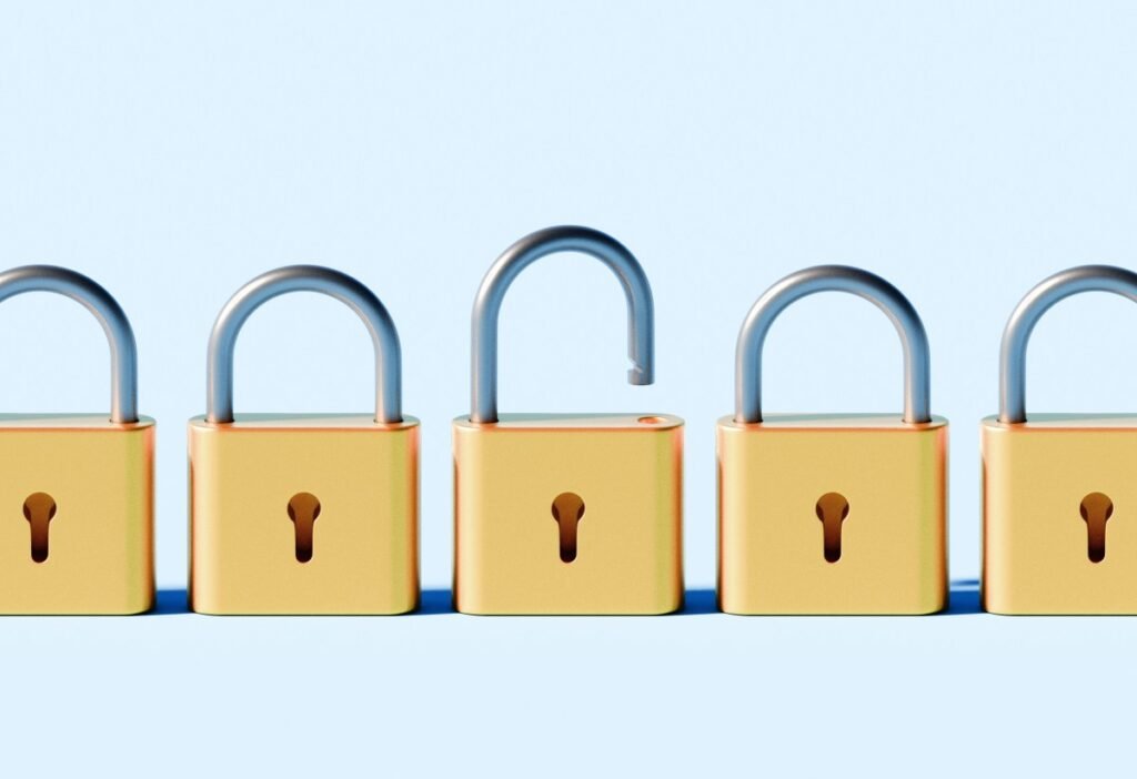 How to tell if your AI platforms’ accounts have been hacked Conceptual stock image depicting a linear row of identical padlocks, all securely locked except for one that is open.