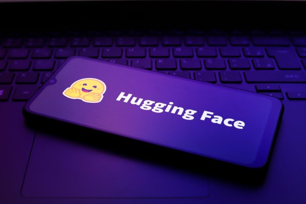 The Hugging Face logo appears on the screen of a smartphone.