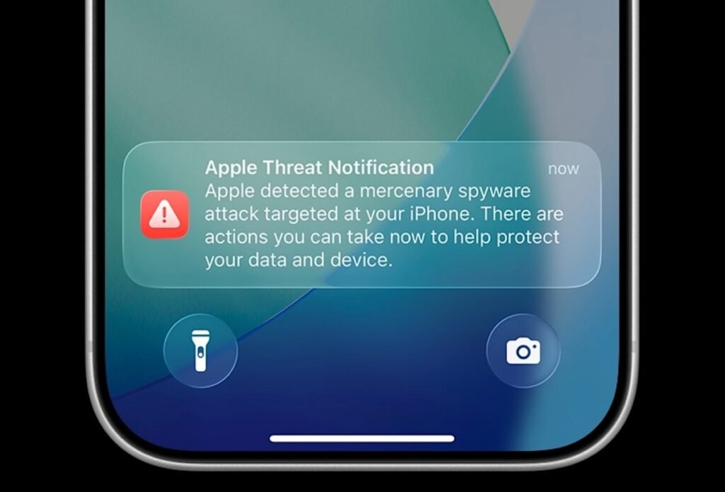 an Apple threat notification on an iPhone lock screen.