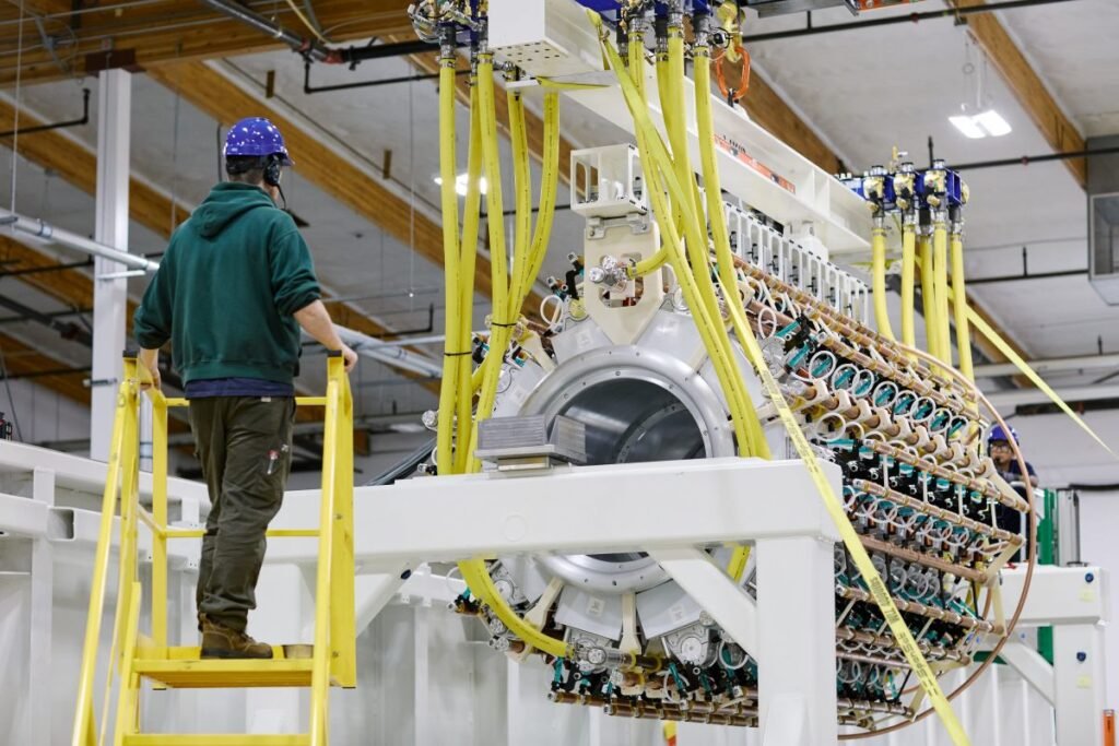 A Pacific Fusion employee inspects a pulser prototype.