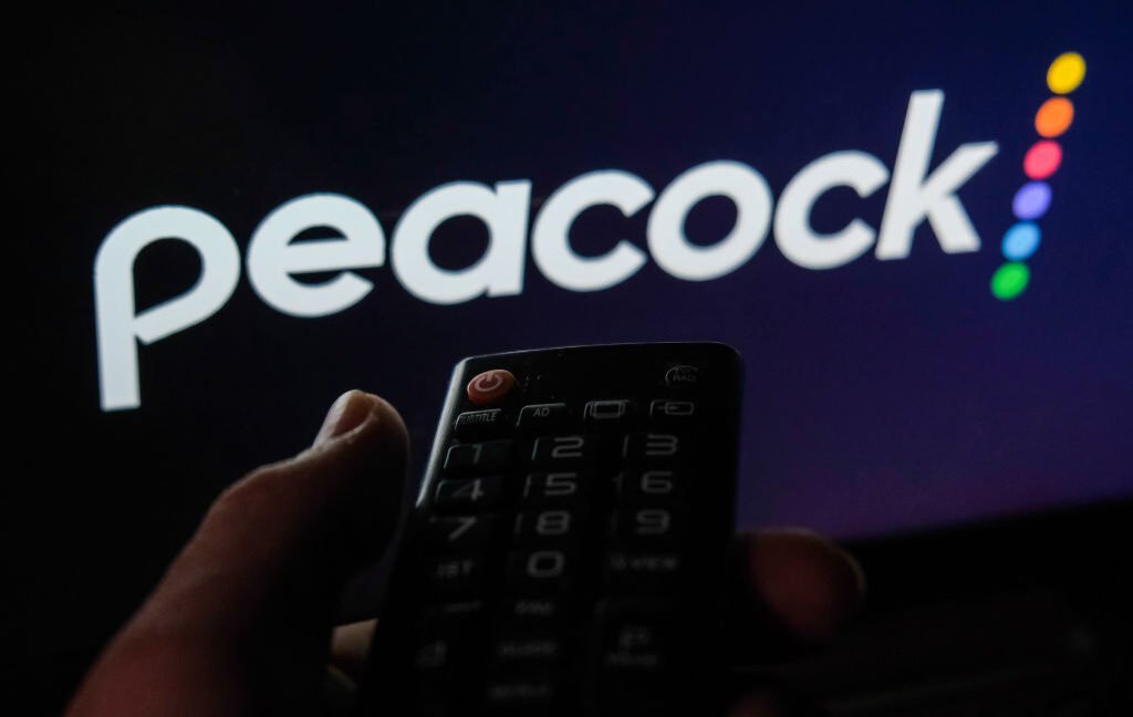 Peacock raises prices by 18 percent after becoming profitable TV remote control is seen with Peacock logo displayed on a screen in this illustration photo taken in Krakow, Poland on February 6, 2022.