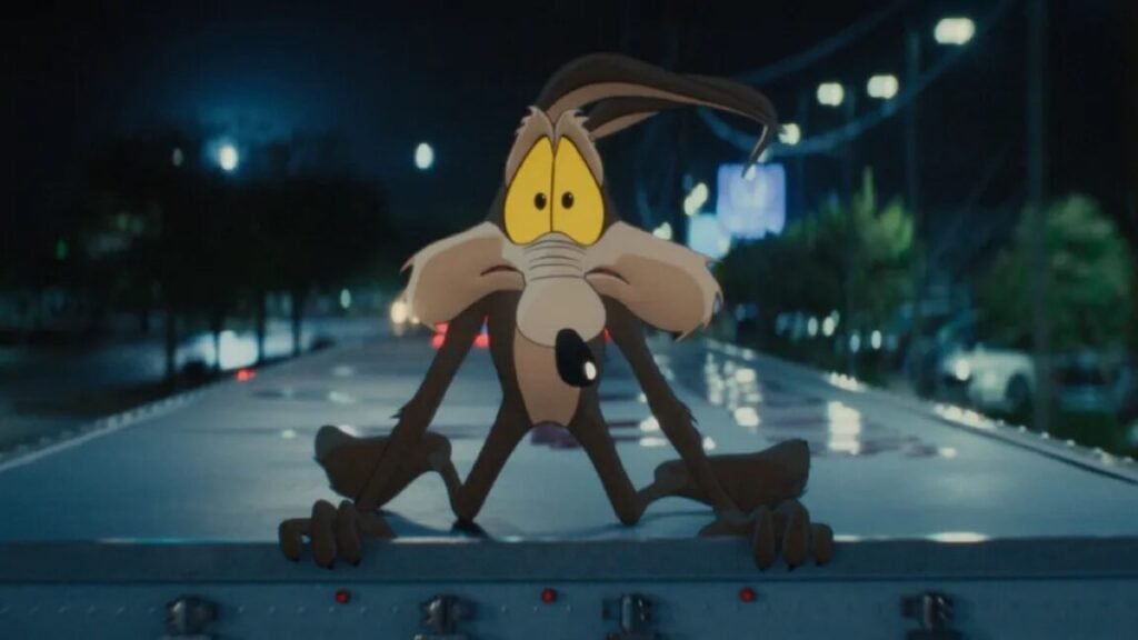 cartoon Wile E. Coyote on hood of car looking in window with a panicked wide-eyed expression
