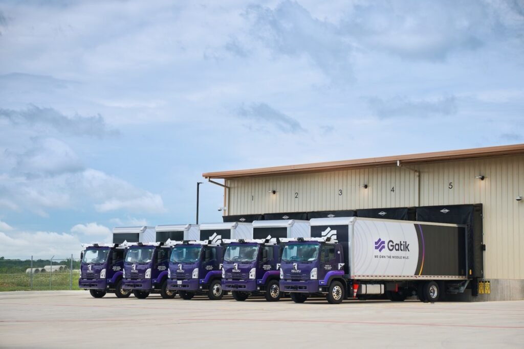 Gatik trucks backed up to loading bays