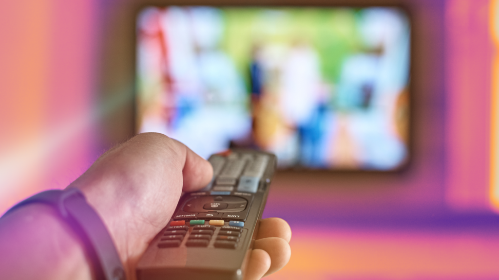 arm pointing remote at tv screen
