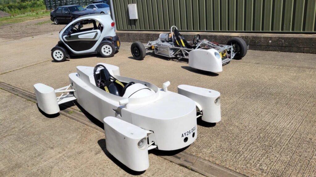 Two hand-made cars and a Renault Twizy.