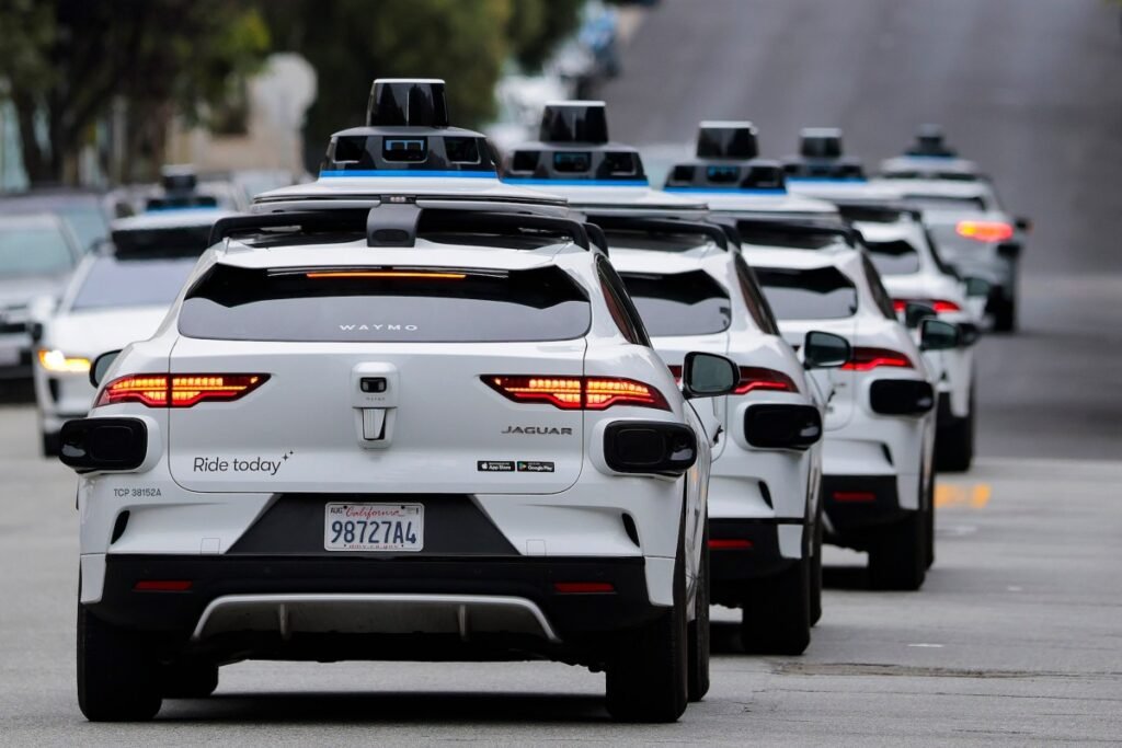A line of Waymo robotaxis drives through North Beach on July 07, 2026 in San Francisco, California.