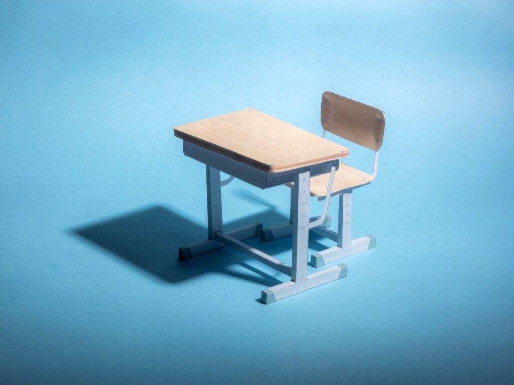 Empty school desk on a blue background.