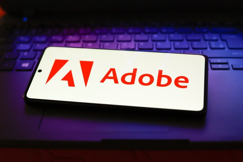 Adobe acquires Indian market intelligence startup Rilo The Adobe Inc. logo displayed on a smartphone screen.