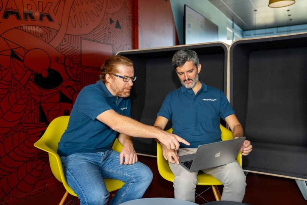 Google DeepMind alumni are building tools to accelerate fusion power for the grid One man points at another's laptop.