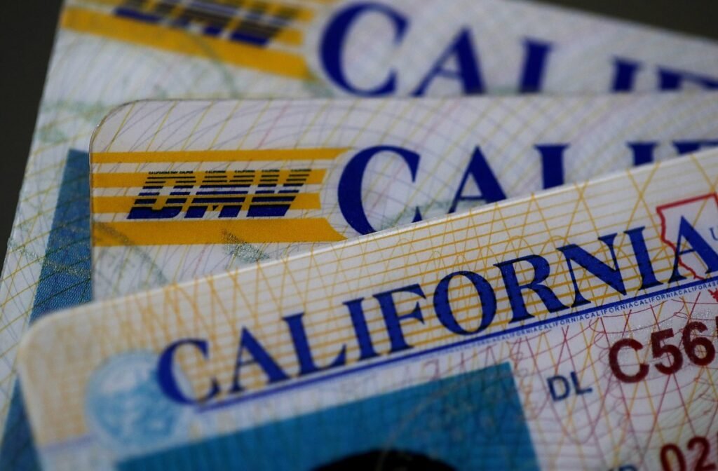 In this photo illustration, the California Department of Motor Vehicles (DMV) logo appears on a California driver license