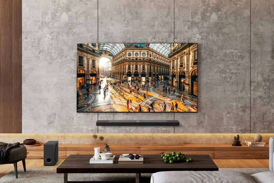 LG TV shown scanning LAN for third-party phones and other devices LG's 83-inch OLED B5 2025 TV. mounted onto a gray wall.