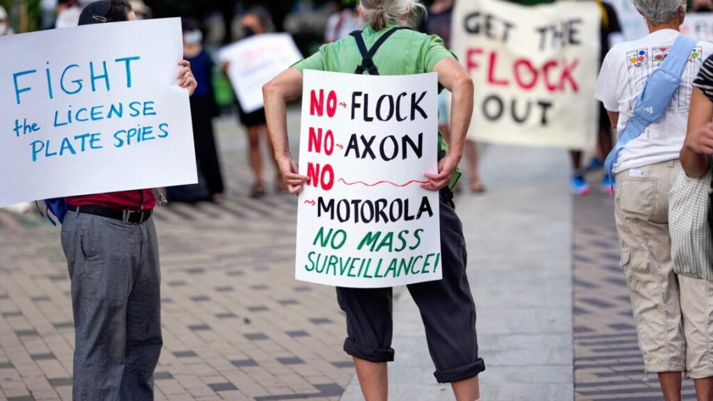 Protesters holding anti-Flock signs