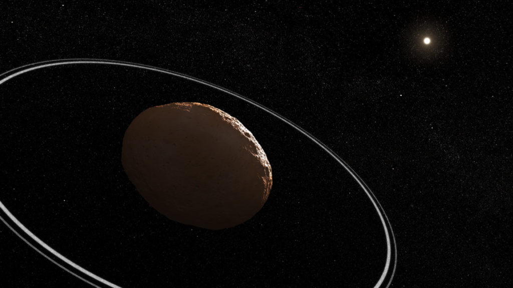 Artist's conception of a lumpy, reddish body, dimly lit by the Sun, with two thin rings surrounding it.