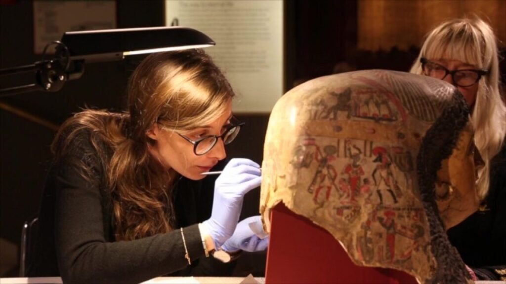 Clara Granzotto, assisted by conservator Inger Jonsson, taking a micro-sample for proteomics analysis from the painted surface of Mummy mask of a woman