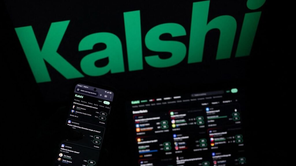 A smartphone and laptop screen display offers of wagers on the Kalshi prediction market