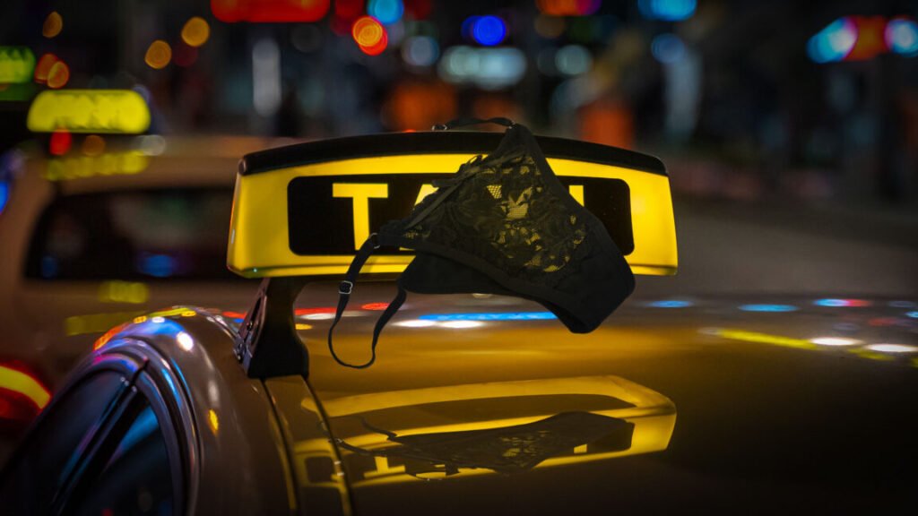 women's underwear on top of an illuminated taxi sign