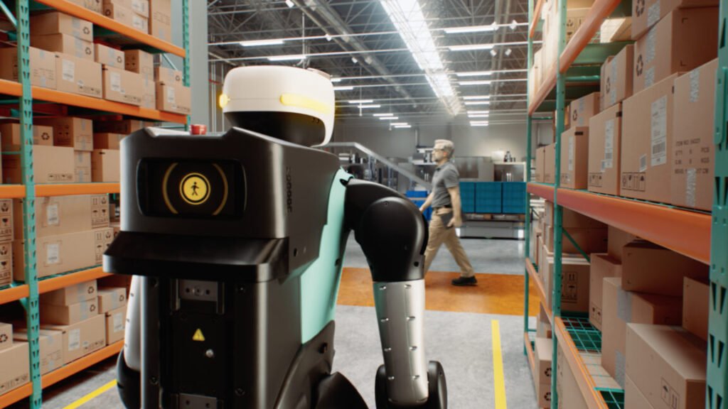 Agility Robotics' Digit humanoid robot uses NVIDIA's Halos system to help safely work around humans. The humanoid robot is seen from behind while standing in a warehouse aisle as a person passes by in the distance.