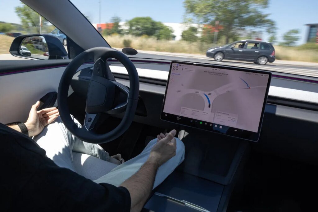 A car driver tests a Tesla's FSD (Full Self Driving) system on a road in Sabadell near Barcelona.